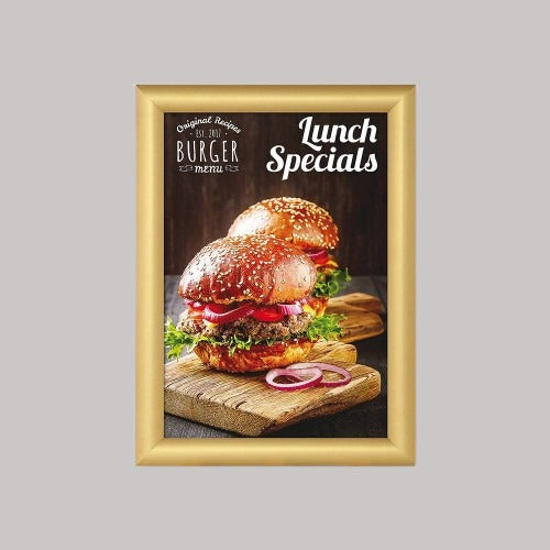 A gold snap frame displaying a poster of a sandwich, with the text 'Lunch Specials' on it, set against a plain background.