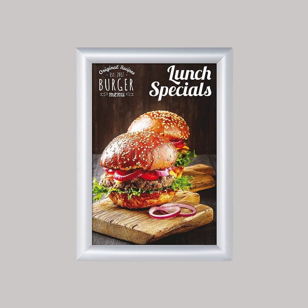 A silver snap frame displaying a poster of a sandwich, with the text 'Lunch Specials' on it, set against a plain background.